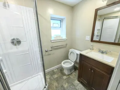 a bathroom with a shower and a toilet and a sink at Private Cozy 2bdrm Sleep5pp Metrotown! Free Parking! Self Check-in! in Burnaby
