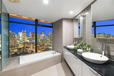 a bathroom with two sinks and a large window at 3-Level Modern Luxury Sub-Penhouse, Best Ocean & City Views - Prime Downtown Location in Vancouver