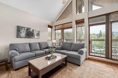a living room with a couch and a table at 2BR in Nicklaus North, Mountain Views, Bright and Spacious, Tranquil Location in Whistler