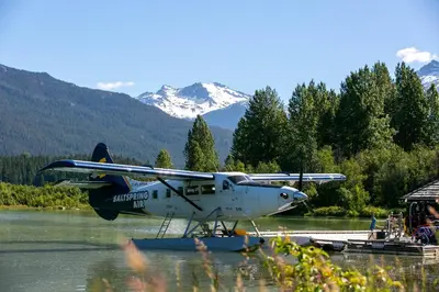 a plane is sitting in the water in a river at 2BR in Nicklaus North, Mountain Views, Bright and Spacious, Tranquil Location in Whistler