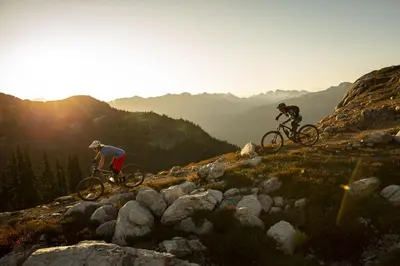 two people riding bikes on top of a mountain at 2BR in Nicklaus North, Mountain Views, Bright and Spacious, Tranquil Location in Whistler