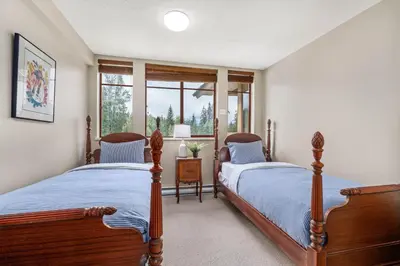 a bedroom with two beds and a window at 2BR in Nicklaus North, Mountain Views, Bright and Spacious, Tranquil Location in Whistler