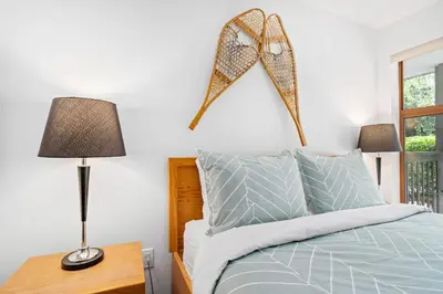 a bedroom with a bed with a star on the wall at 1BR in Northstar, Village Location, Hot Tub, Gas Fireplace, Secure Parking, Ski Storage in Whistler