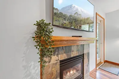 a fireplace with a view of a mountain at 1BR in Northstar, Village Location, Hot Tub, Gas Fireplace, Secure Parking, Ski Storage in Whistler