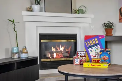 a table in a living room with a fireplace at Cozy Modern Pet Friendly Homes in Calgary