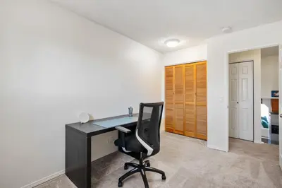 an office with a black desk and a chair at Cozy Modern Pet Friendly Homes in Calgary
