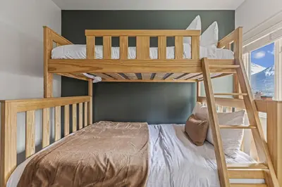a couple of bunk beds in a room at Amazing mountain Views 3BR Penthouse with private Balconies in Canmore