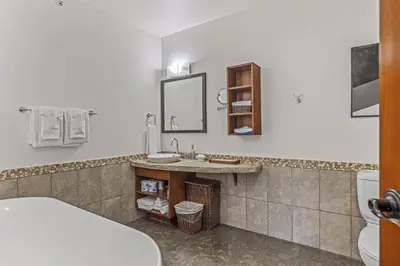 a bathroom with a sink and a toilet at Amazing mountain Views 3BR Penthouse with private Balconies in Canmore
