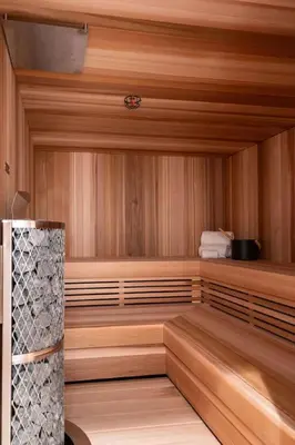 a sauna with wood paneled walls and a wooden floor at Sitka Spruce Mountain Chalet in Revelstoke
