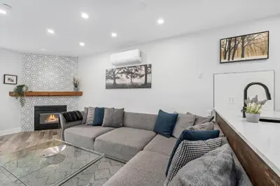 a living room with a couch and a fireplace at 1BR and Den in Marketplace Lodge, Village Location, Mountain Views, Gas Fireplace, Parking in Whistler