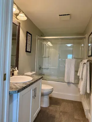 a bathroom with a toilet and a tub and a sink at Lakefront Suite on Shawnigan Lake in Shawnigan Lake