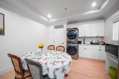 a kitchen with a table with chairs and a washing machine at Guest suite in Richmond in Richmond