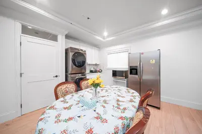 a dining room with a table and a refrigerator at Guest suite in Richmond in Richmond