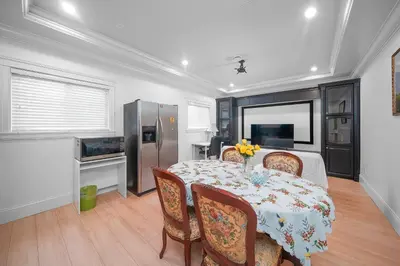 a dining room with a table with chairs and a refrigerator at Guest suite in Richmond in Richmond
