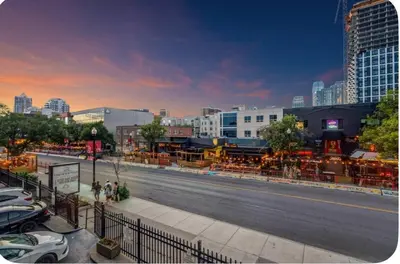 a city street with cars parked on the side of a road at 17th Ave Cozy Nest in Downtown Calgary with Parking in Calgary