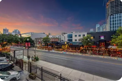 a city street with cars parked on the side of a road at 17th Ave Cozy Nest in Downtown Calgary with Parking in Calgary