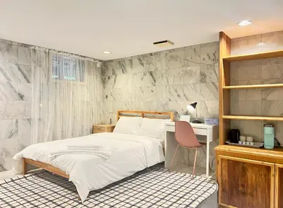 a bedroom with a white bed and a desk at Luxurious and quiet room in Vancouver's West End in Vancouver
