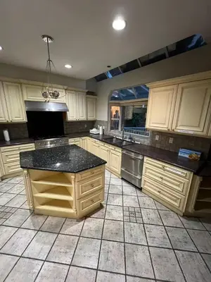 a kitchen with white cabinets and a black counter top at Luxurious and quiet room in Vancouver's West End in Vancouver