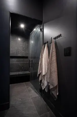 a bathroom with a glass shower and towels at Mountain Lake Luxury Ski Chalet in Revelstoke