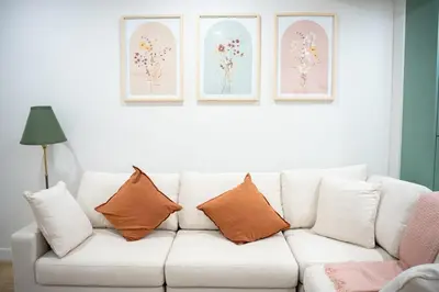 a white couch with pillows in a living room at Modern Luxury Stay - Airport, Banff, Rockies Route in Calgary