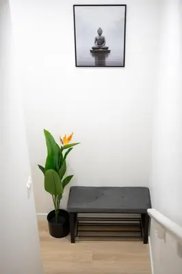 a room with a bench and a potted plant at Modern Luxury Stay - Airport, Banff, Rockies Route in Calgary