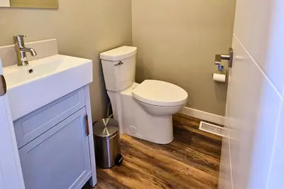 a bathroom with a white toilet and a sink at Cloudline Vista 3 BdrmTownhouse with Garage managed by Little Sister Getaways in Canmore