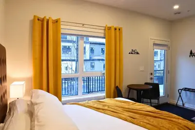 a bedroom with a bed and a large window at Cloudline Vista 3 BdrmTownhouse with Garage managed by Little Sister Getaways in Canmore