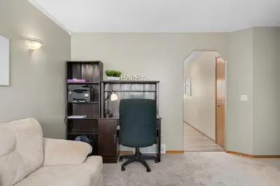 a living room with a desk and a chair at Peacock Suites in Airdrie