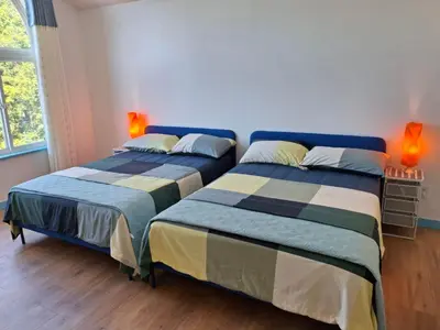 two beds sitting next to each other in a room at Blue Villa by the Sea in Sechelt