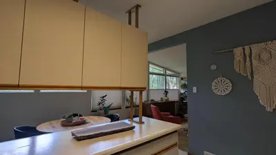 a kitchen with a table and a dining room at YEGFamilyHome in Edmonton