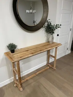 a wooden table with a mirror on the wall at A3 Home in Secord in Edmonton