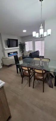 a living room with a glass table and chairs at A3 Home in Secord in Edmonton