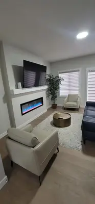 a living room with a couch and a fireplace at A3 Home in Secord in Edmonton