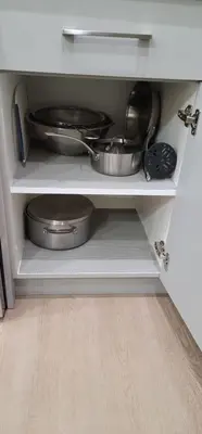 a kitchen shelf with pots and pans on it at A3 Home in Secord in Edmonton