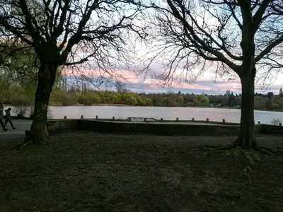 a person walking next to a body of water at Garden View double room suite at Trout Lake in Vancouver