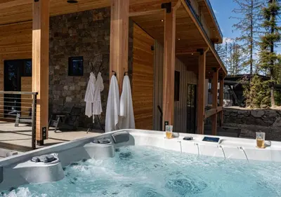 a hot tub in front of a house at Ghost Peak Chalet - Ski-In Access in Port Mann