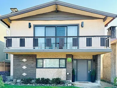 a house with a balcony on top of it at 4BR 2BA Downtown-View Cozy House with Parking, Pet-Free in Vancouver