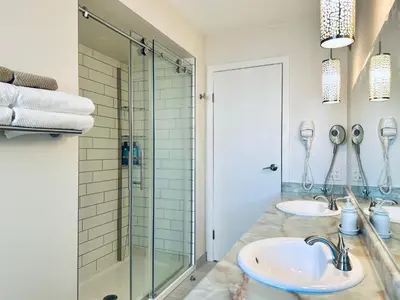 a bathroom with two sinks and a shower at 4BR 2BA Downtown-View Cozy House with Parking, Pet-Free in Vancouver
