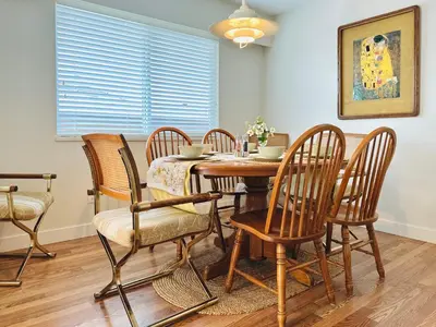 a dining room with a wooden table and chairs at 4BR 2BA Downtown-View Cozy House with Parking, Pet-Free in Vancouver