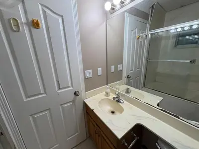 a bathroom with a sink and a mirror at Delta Guest House - Scott Rd & Rapid Transit - Airport 20 Min - Free Parking & Fast Wi-Fi in Delta