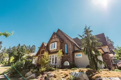 a large brick house with a gambrel roof at Grace Guest House in White Rock