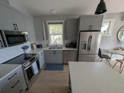 a kitchen with white appliances and a counter top at Lakeview Hideaway in Victoria