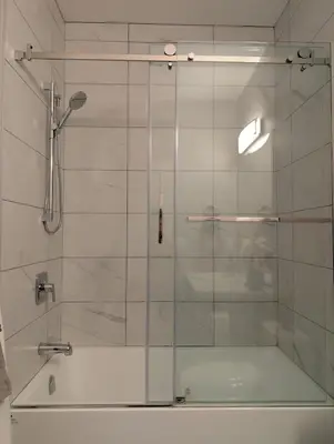 a shower with a glass door in a bathroom at Lakeview Hideaway in Victoria