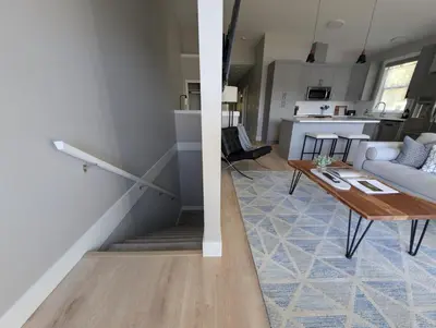 a living room and kitchen with a table and a living room at Lakeview Hideaway in Victoria
