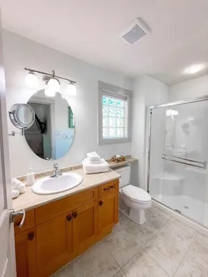 a bathroom with a toilet and a sink and a shower at Oceanside Resort 3 BED 2 BATH with Indoor Pool and Hot Tub in Parksville