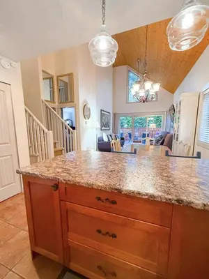 a kitchen with a counter and a dining room at Oceanside Resort 3 BED 2 BATH with Indoor Pool and Hot Tub in Parksville