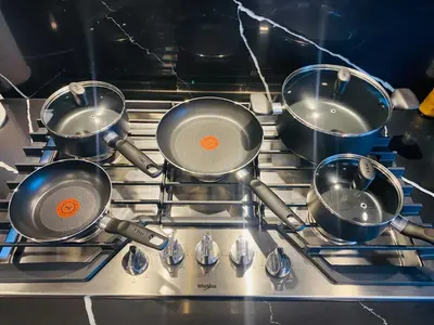 four pots on a stove in a kitchen at NEW Luxury Family Friendly Entire House Near Downtown WEM, 3 Bedrooms in Edmonton