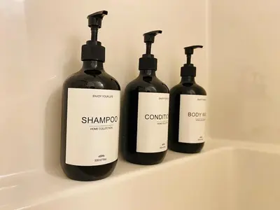 three bottles of wine sitting on a shelf at NEW Luxury Family Friendly Entire House Near Downtown WEM, 3 Bedrooms in Edmonton