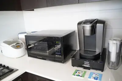 a microwave sitting on top of a kitchen counter at Cozy Richmond Center Downtown 2B & 2B Apartment in Richmond