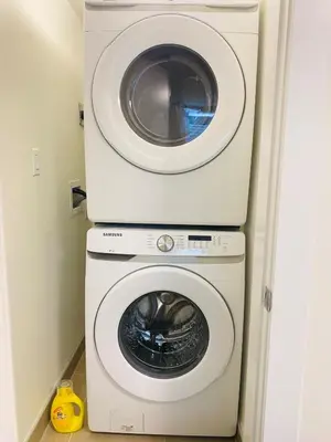 a washing machine and a dryer in a room at Modern Cozy Entire Guest Suite in Central Edmonton in Edmonton